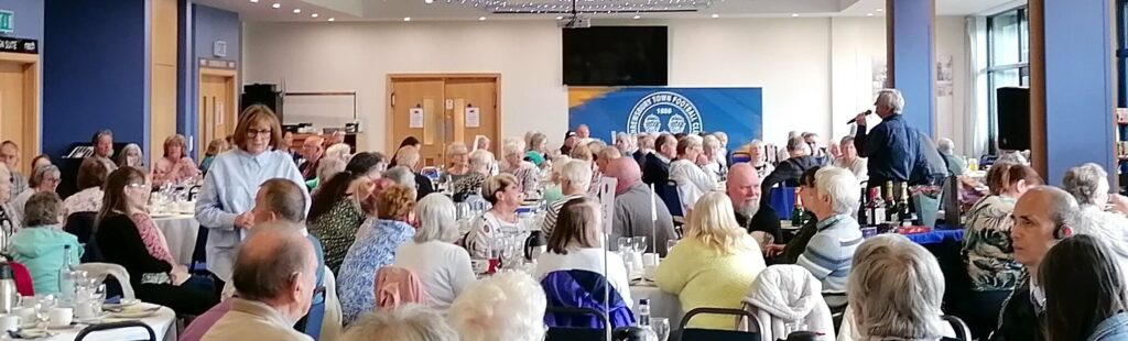 A large function room of guests enjoying the party at Sight Loss Shropshire's Spring Day Out