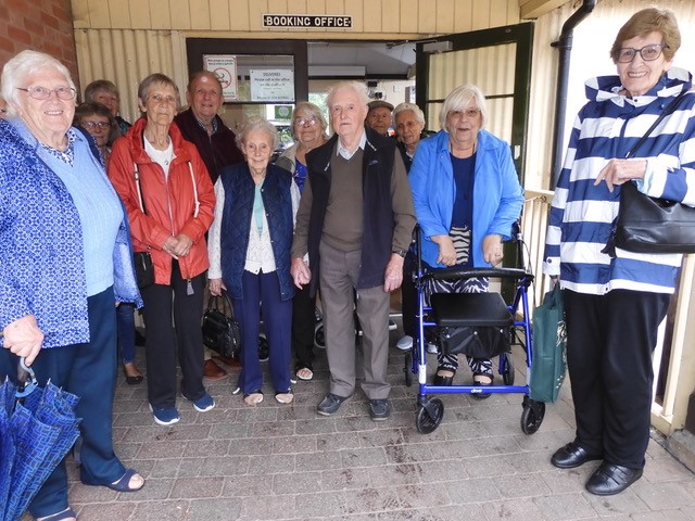 Newport VIP Group members standing outside the Welshpool Llanfair Caereinion Light Railway station's  booking office